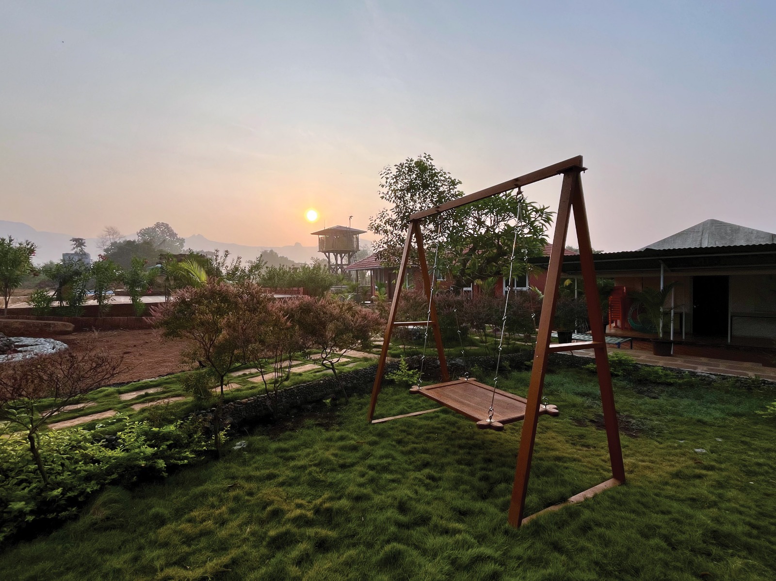 Swing at sunrise on the resort grounds at Mitraay Resort
