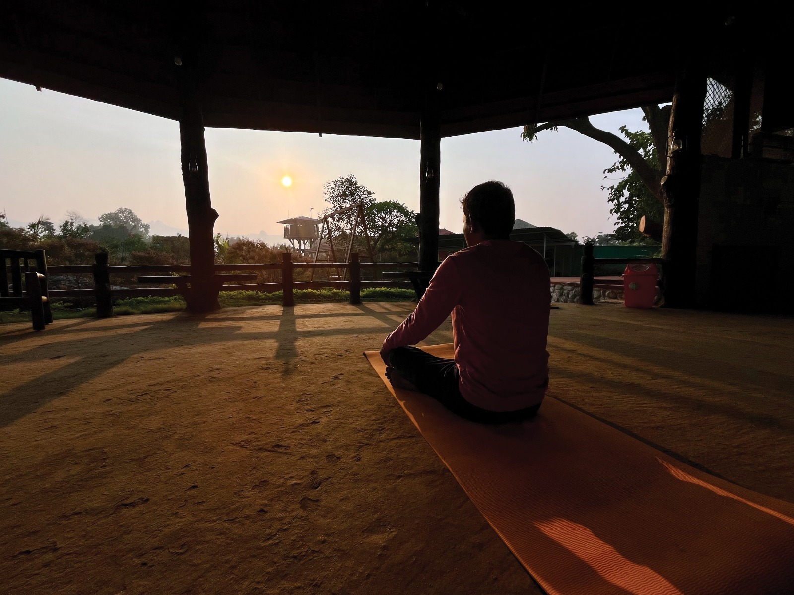 Wide-angle meditation at sunrise in Mitraay Resort pavilion