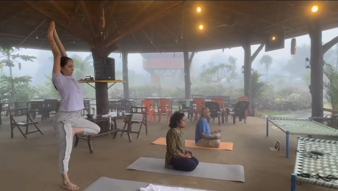 Yoga practice in the open pavilion during rain at Mitraay Resort