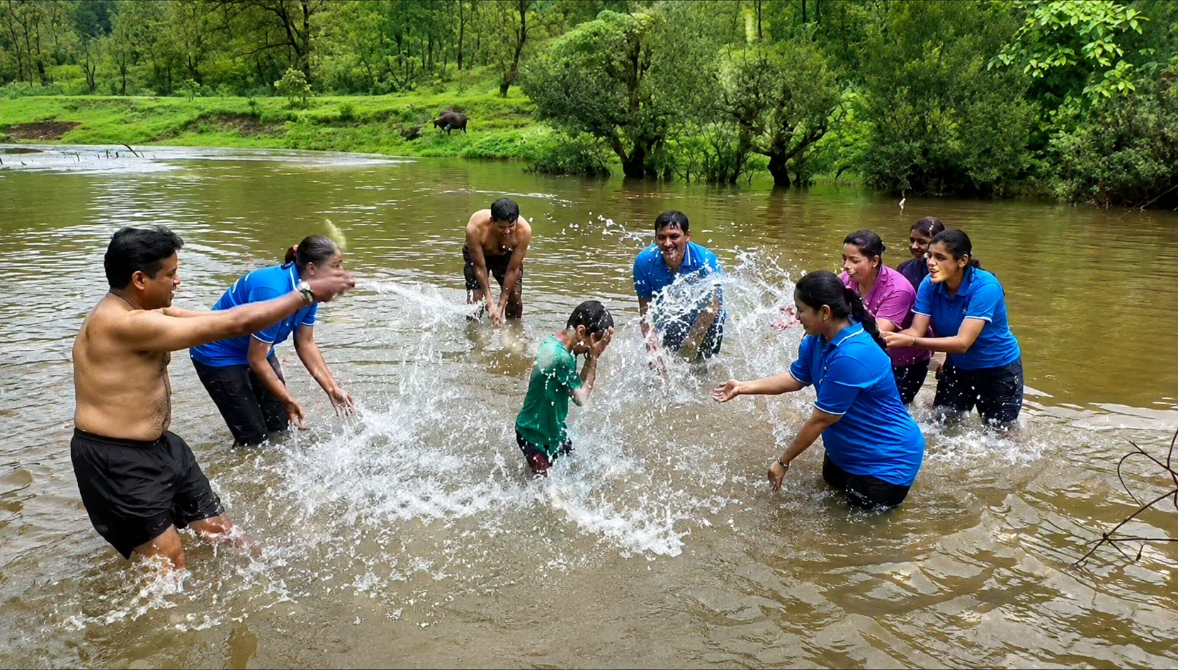 School group playing and bathing in the river at Mitraay Resort