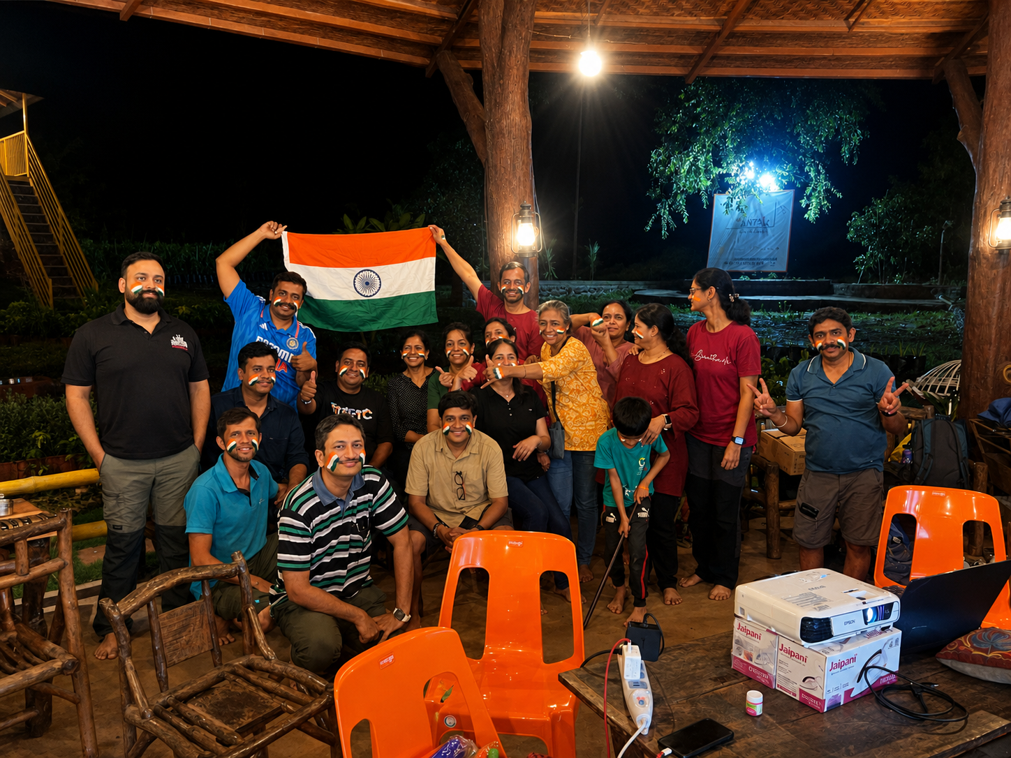 Group gathering at night with flag at Mitraay Resort